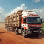 a large transport truck branded with ‘affordable business consortium sl ltd.’ logo, carrying sacks of cassava and corn, driving on a rural sierra leone road, realistic african landscape.